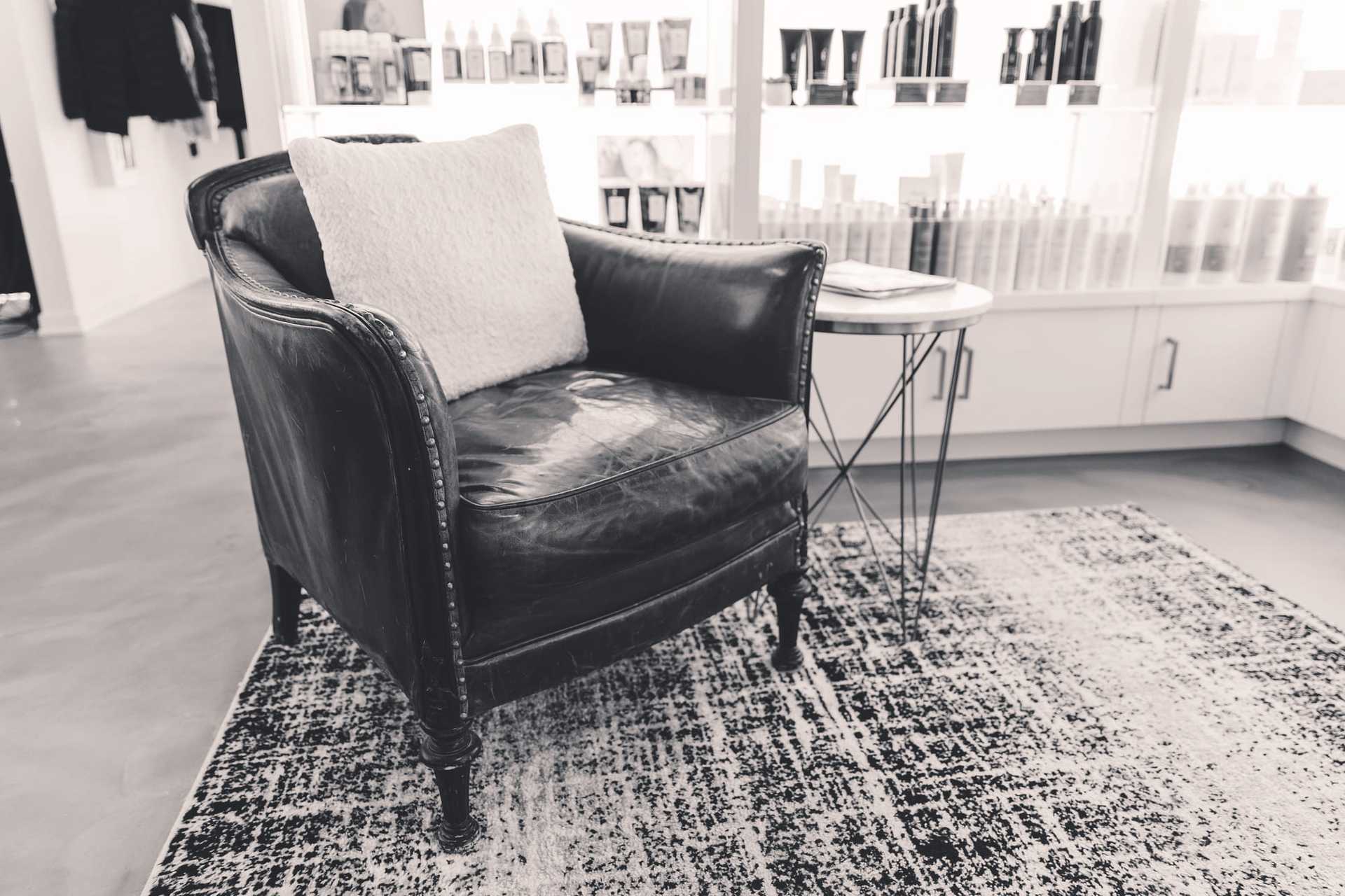 Vintage leather armchair with cushion in a chic room.